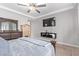 Stylish bedroom with dark wood furniture, a ceiling fan, and a mounted television at 16268 W Cortez St, Surprise, AZ 85379