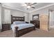 Cozy bedroom with a large bed, ceiling fan, and ample natural light streaming through the windows at 16268 W Cortez St, Surprise, AZ 85379