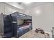Bedroom with blue bunk beds with stairs, carpet flooring and light gray walls at 16268 W Cortez St, Surprise, AZ 85379