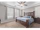 Comfortable primary bedroom featuring a decorative ceiling fan, large windows, and natural light at 16268 W Cortez St, Surprise, AZ 85379