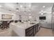 Spacious kitchen island connects to dining and living spaces, with modern countertops and sleek cabinets at 16268 W Cortez St, Surprise, AZ 85379