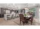 Gourmet kitchen with a large island and breakfast bar adjoining an elegant dining area at 16268 W Cortez St, Surprise, AZ 85379