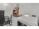 Clean laundry room with modern washer and dryer units with overhead shelving at 16268 W Cortez St, Surprise, AZ 85379