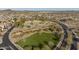 Wide aerial view highlighting green community spaces with playgrounds, picnic areas, and mature trees at 16462 W Rowel Rd, Surprise, AZ 85387