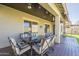 Outdoor patio with seating and view of the artificial grass backyard, great for relaxing at 16462 W Rowel Rd, Surprise, AZ 85387