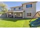 Home backyard with artificial grass, covered patio and play structure at 16462 W Rowel Rd, Surprise, AZ 85387
