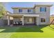 Exterior view of home, showing the backyard, covered patio, and artificial grass lawn at 16462 W Rowel Rd, Surprise, AZ 85387