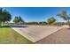 A community basketball court with mature trees, providing recreational activities for residents at 16462 W Rowel Rd, Surprise, AZ 85387