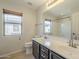 Bathroom featuring double vanity, large mirror and natural light at 16462 W Rowel Rd, Surprise, AZ 85387