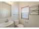 Well lit half bath with nice vanity and toilet at 16462 W Rowel Rd, Surprise, AZ 85387