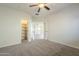 Neutral bedroom featuring a ceiling fan, carpet floors, and closet at 16462 W Rowel Rd, Surprise, AZ 85387