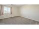 Cozy bedroom featuring gray carpet, window and neutral walls at 16462 W Rowel Rd, Surprise, AZ 85387