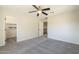 Bedroom features gray carpet, walk in closet and neutral walls at 16462 W Rowel Rd, Surprise, AZ 85387