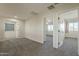 Bright bedroom boasts neutral walls, gray carpet and ample natural light at 16462 W Rowel Rd, Surprise, AZ 85387
