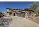 Spacious two-story home boasting a three-car garage, stone accents, and a well-maintained yard at 16462 W Rowel Rd, Surprise, AZ 85387
