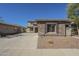 Charming single-story home showcasing stone accents, desert landscaping, and a private driveway at 16462 W Rowel Rd, Surprise, AZ 85387