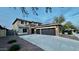 Charming two-story home with a three car garage, stone accents, and a concrete driveway at 16462 W Rowel Rd, Surprise, AZ 85387