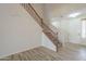 Bright foyer showcasing a staircase with wooden railing and tiled floors leading into the home at 16462 W Rowel Rd, Surprise, AZ 85387