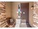 Inviting front porch featuring a cozy bench and a stately wood door with sidelight at 16462 W Rowel Rd, Surprise, AZ 85387