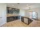 A kitchen offers dark cabinetry, stainless steel appliances and a view to the outdoor space at 16462 W Rowel Rd, Surprise, AZ 85387