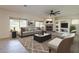 Cozy living room features a stone fireplace, built-in shelving, and large windows with outdoor views at 16462 W Rowel Rd, Surprise, AZ 85387