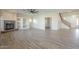 Inviting living room with a fireplace, built-in shelving, and stairs to the upper level at 16462 W Rowel Rd, Surprise, AZ 85387