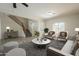 Cozy living room area featuring seating and a staircase leading to the home's second level at 16462 W Rowel Rd, Surprise, AZ 85387