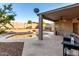 Backyard with a covered patio, ceiling fan, mature landscaping, and a pebble tec pool at 1701 E Yukon Dr, Phoenix, AZ 85024