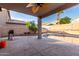 Enjoy the covered patio, ceiling fan and a pebble tec pool in this private backyard at 1701 E Yukon Dr, Phoenix, AZ 85024
