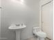 Bathroom featuring a pedestal sink and toilet at 1701 E Yukon Dr, Phoenix, AZ 85024