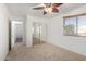 Bedroom with mirrored closet doors and ceiling fan at 1701 E Yukon Dr, Phoenix, AZ 85024