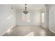 The dining room has neutral tile flooring, a Tiffany style light fixture, and a bright window at 1701 E Yukon Dr, Phoenix, AZ 85024