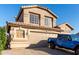 This desert home has a two-car garage and a glimpse of a blue Jeep parked in the drive at 1701 E Yukon Dr, Phoenix, AZ 85024