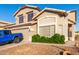 Charming home with well-maintained landscaping, a rock garden, and a peek at a blue Jeep parked outside the garage at 1701 E Yukon Dr, Phoenix, AZ 85024