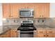 The kitchen showcases modern stainless steel appliances and granite countertops at 1701 E Yukon Dr, Phoenix, AZ 85024