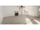 Open living area with neutral tile flooring, a cozy fireplace, and recessed shelving at 1701 E Yukon Dr, Phoenix, AZ 85024