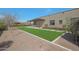 Large backyard featuring desert landscaping, artificial turf, and a pergola covered patio at 17756 E Colt Dr, Queen Creek, AZ 85142