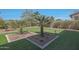 Putting green in backyard with desert landscaping, creating a private retreat at 17756 E Colt Dr, Queen Creek, AZ 85142