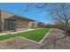 Spacious backyard with a pergola, built in BBQ, artificial turf, and desert landscaping at 17756 E Colt Dr, Queen Creek, AZ 85142