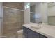 Modern bathroom features a glass shower, stylish vessel sink, and sleek blue vanity at 17756 E Colt Dr, Queen Creek, AZ 85142