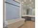Bright bathroom with a soaking tub, vanity, and large windows at 17756 E Colt Dr, Queen Creek, AZ 85142