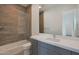 Bathroom featuring quartz countertop vanity, glass shower, and wood tiled shower walls at 17756 E Colt Dr, Queen Creek, AZ 85142