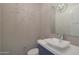 Stylish powder room featuring modern fixtures and textured tile wall at 17756 E Colt Dr, Queen Creek, AZ 85142