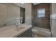 Bathroom featuring quartz countertop vanity, glass shower, and wood tiled shower walls at 17756 E Colt Dr, Queen Creek, AZ 85142