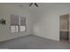 Clean bedroom with neutral walls, tiled floors, and an ensuite bathroom at 17756 E Colt Dr, Queen Creek, AZ 85142