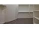 Walk-in closet with carpet flooring and built-in shelving at 17756 E Colt Dr, Queen Creek, AZ 85142