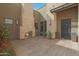 Private front patio with a stone fireplace, desert landscaping and an entrance to a modern, single-Gathering home at 17756 E Colt Dr, Queen Creek, AZ 85142
