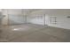 Garage with epoxy floors, garage door and storage shelves at 17756 E Colt Dr, Queen Creek, AZ 85142