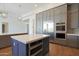 Gourmet kitchen island with stainless steel appliances, custom cabinetry, and a sleek, modern design at 17756 E Colt Dr, Queen Creek, AZ 85142