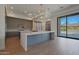 Stylish kitchen with stainless steel appliances, an extended kitchen island, and an open view to the outdoor space at 17756 E Colt Dr, Queen Creek, AZ 85142
